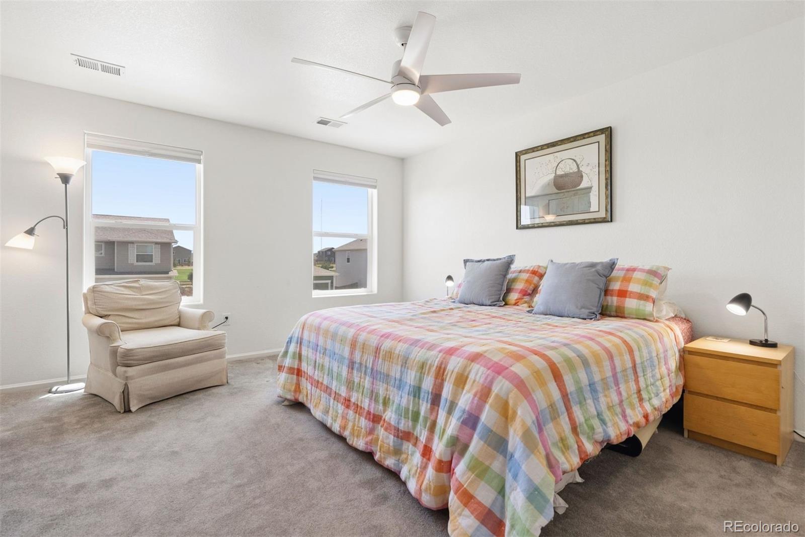 7307 Animas Avenue Frederick, CO 80530 - Photo 25 of 49 a bedroom with bed and a chandelier