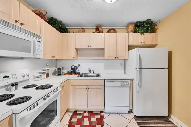a kitchen with a white cabinets and white appliances
