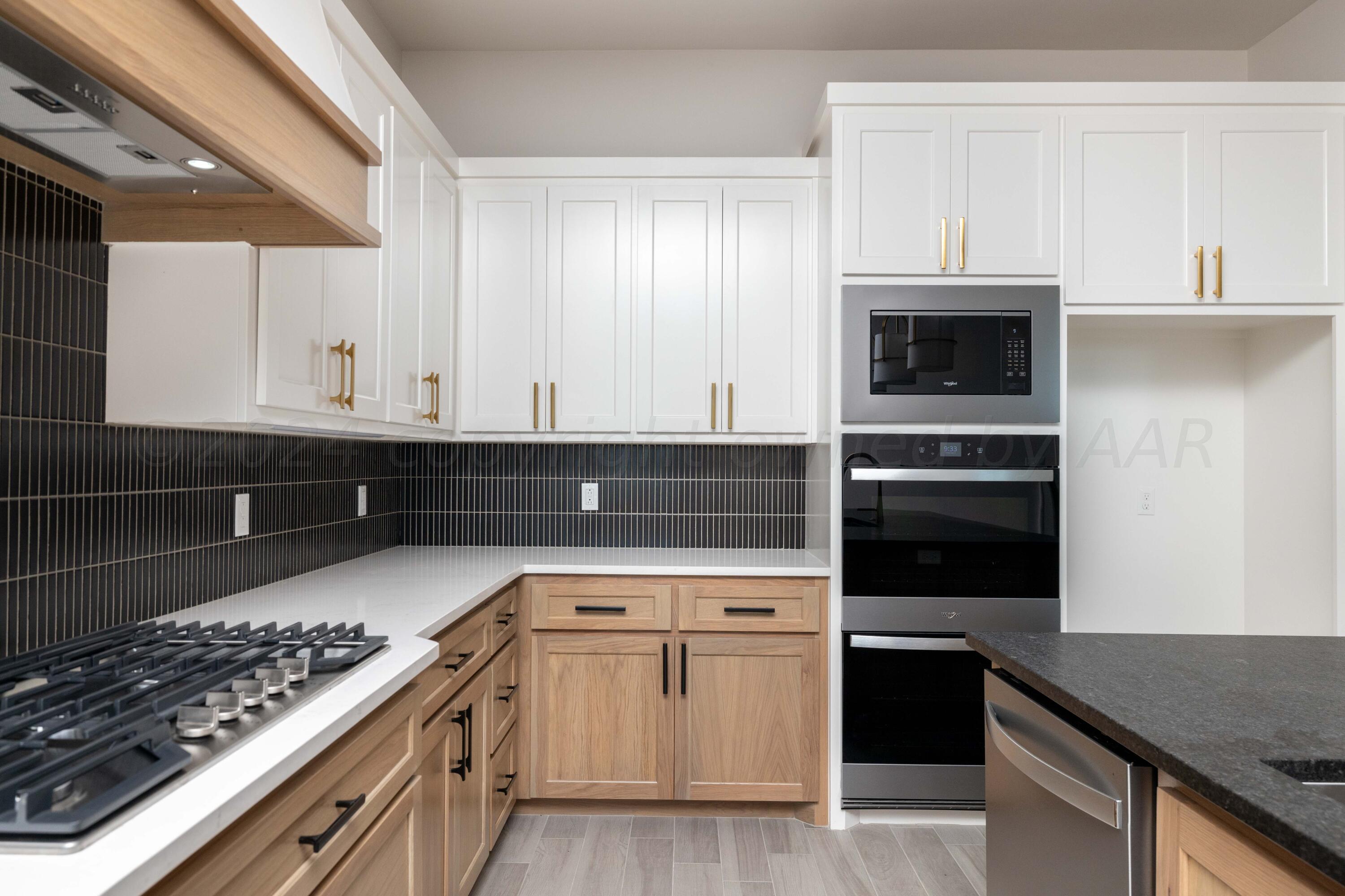10201 Cactus Flower Road Amarillo, TX 79119 - Photo 11 of 48 a kitchen with kitchen island granite countertop a stove and a sink