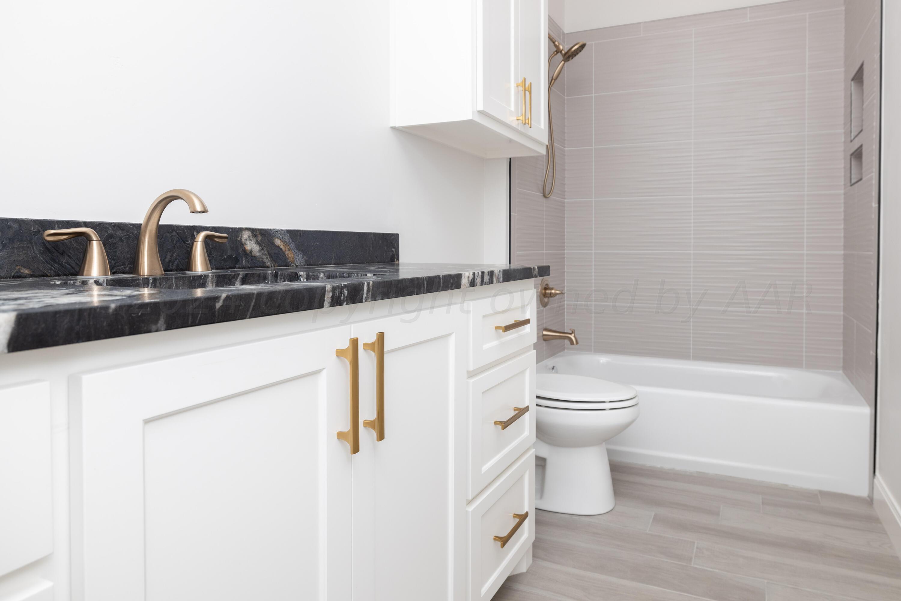 10201 Cactus Flower Road Amarillo, TX 79119 - Photo 15 of 48 a bathroom with a granite countertop toilet sink and mirror
