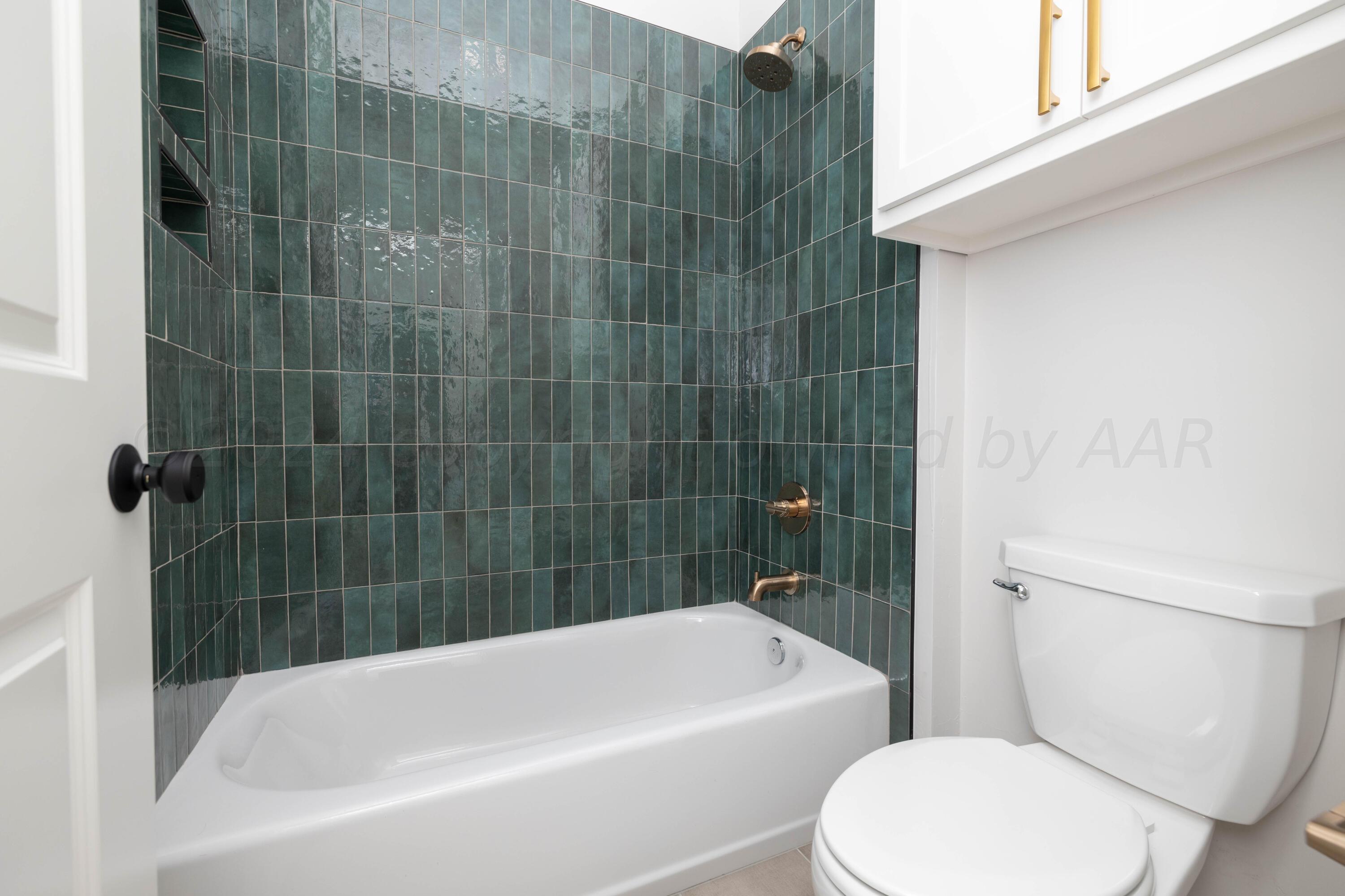 10201 Cactus Flower Road Amarillo, TX 79119 - Photo 27 of 48 a white bath tub sitting next to a white toilet