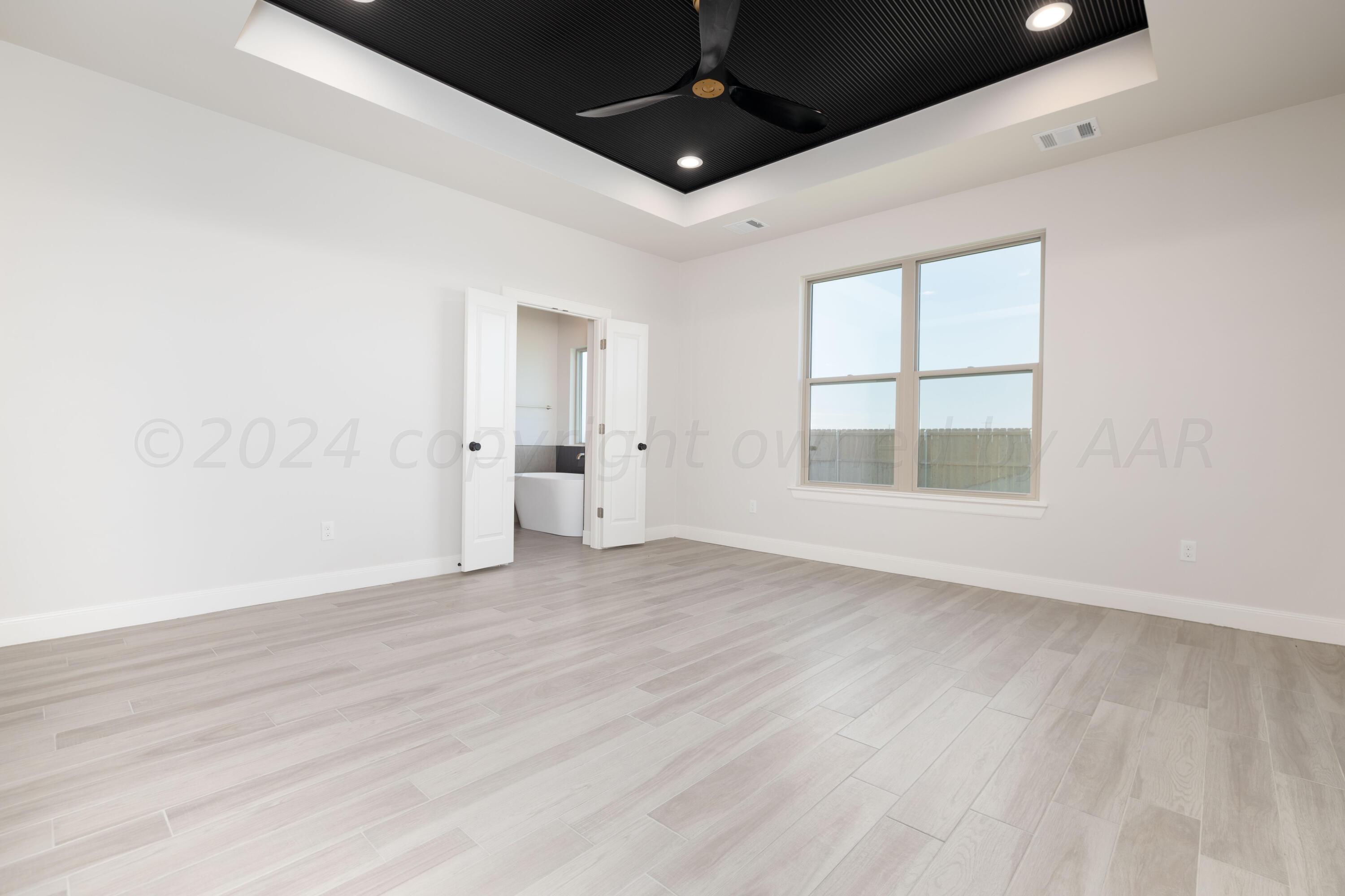 10201 Cactus Flower Road Amarillo, TX 79119 - Photo 29 of 48 an empty room with wooden floor and windows