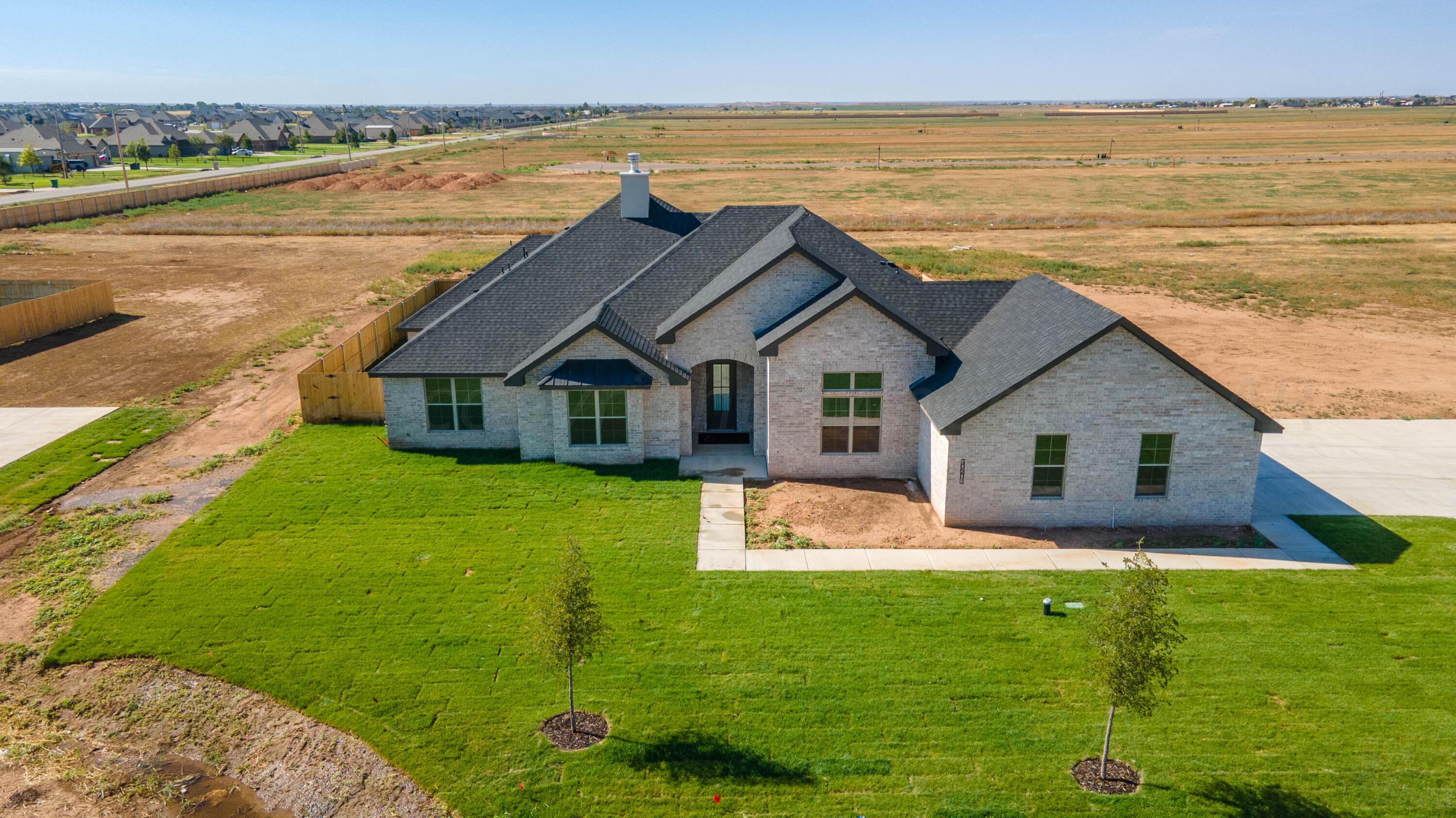 10201 Cactus Flower Road Amarillo, TX 79119 - Photo 45 of 48 a front view of house with yard and lake view