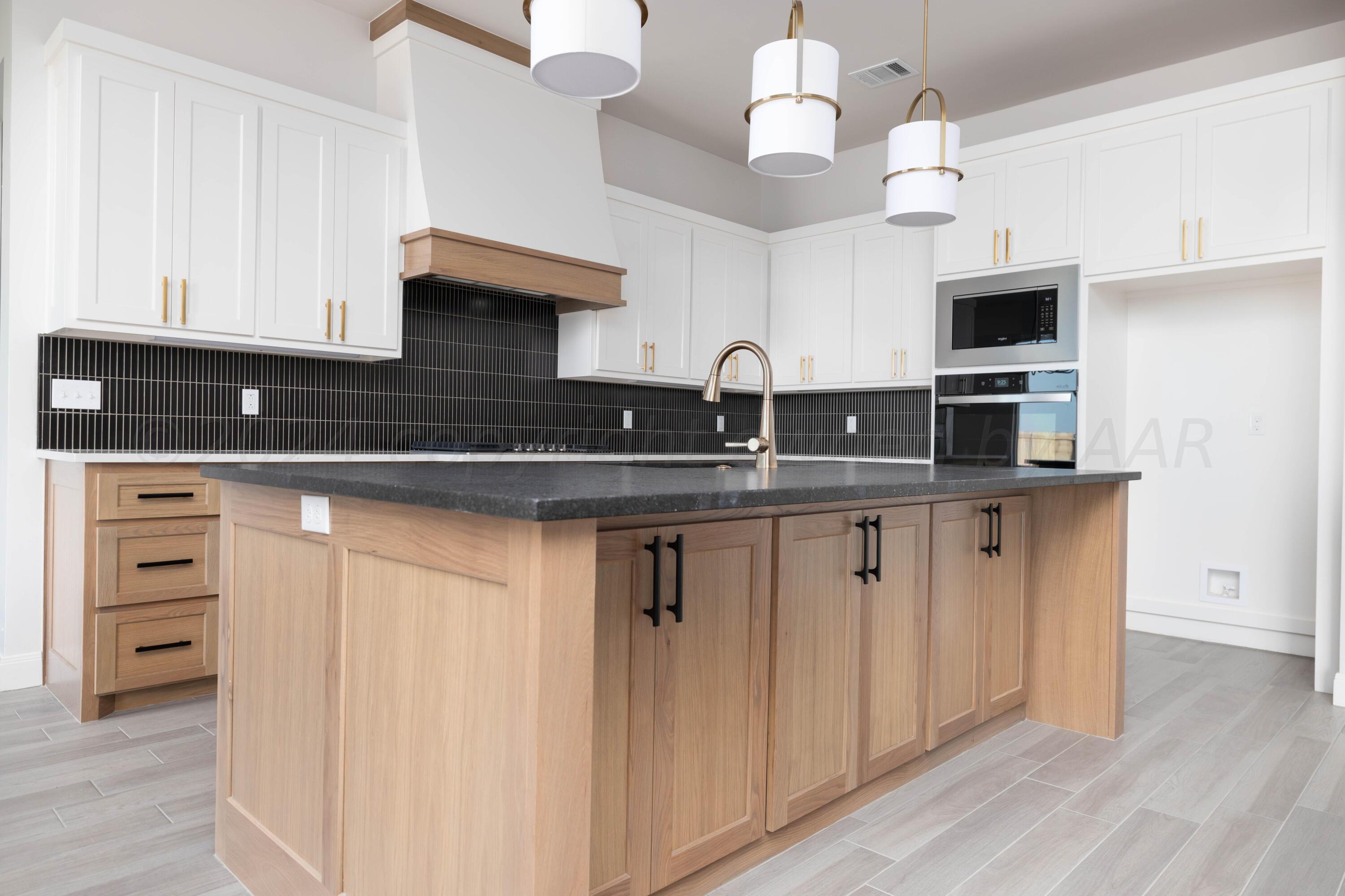 10201 Cactus Flower Road Amarillo, TX 79119 - Photo 5 of 48 a kitchen with stainless steel appliances granite countertop a sink and dishwasher with white cabinets