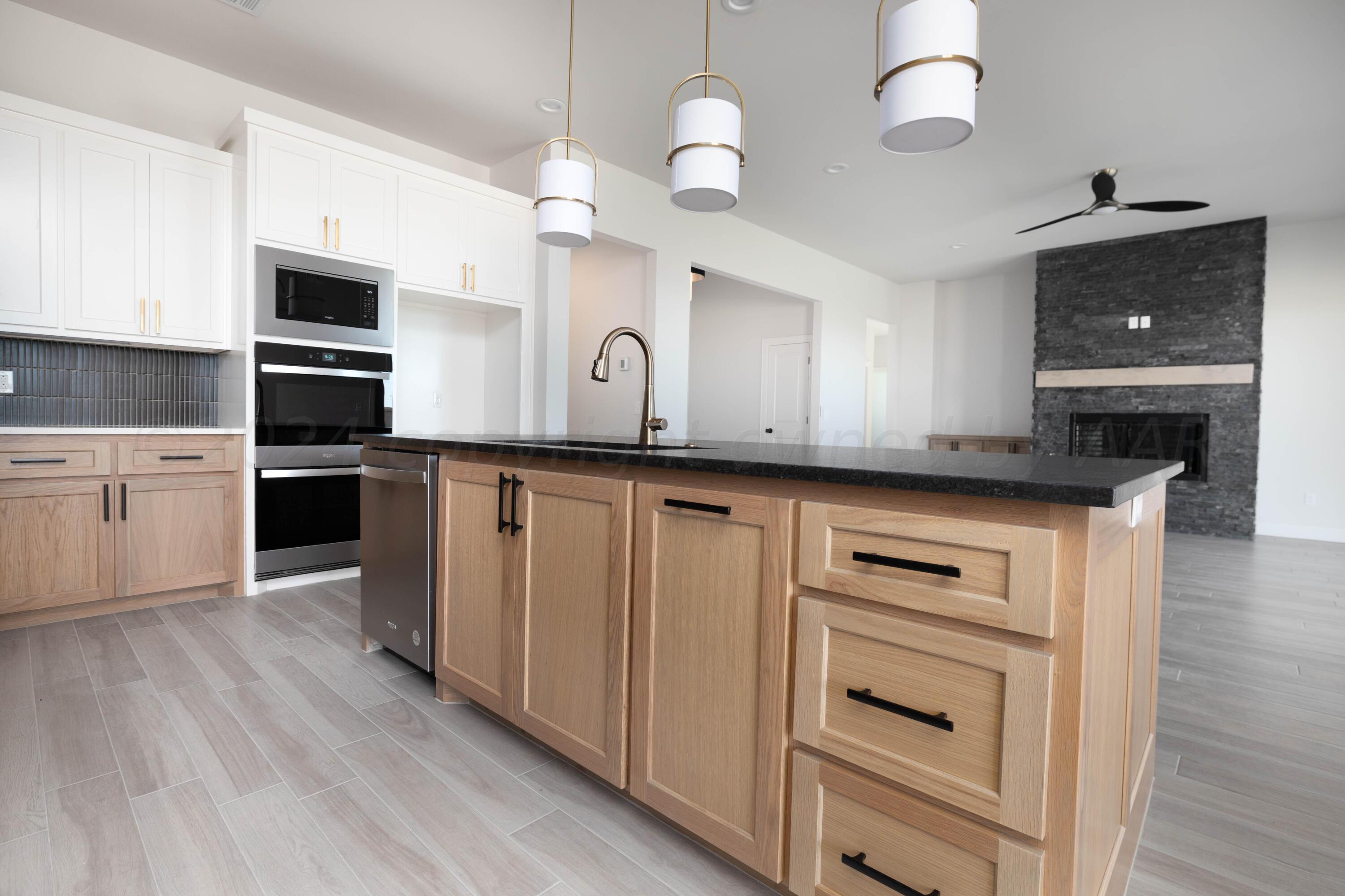 10201 Cactus Flower Road Amarillo, TX 79119 - Photo 7 of 48 a kitchen with granite countertop a sink stainless steel appliances and cabinets