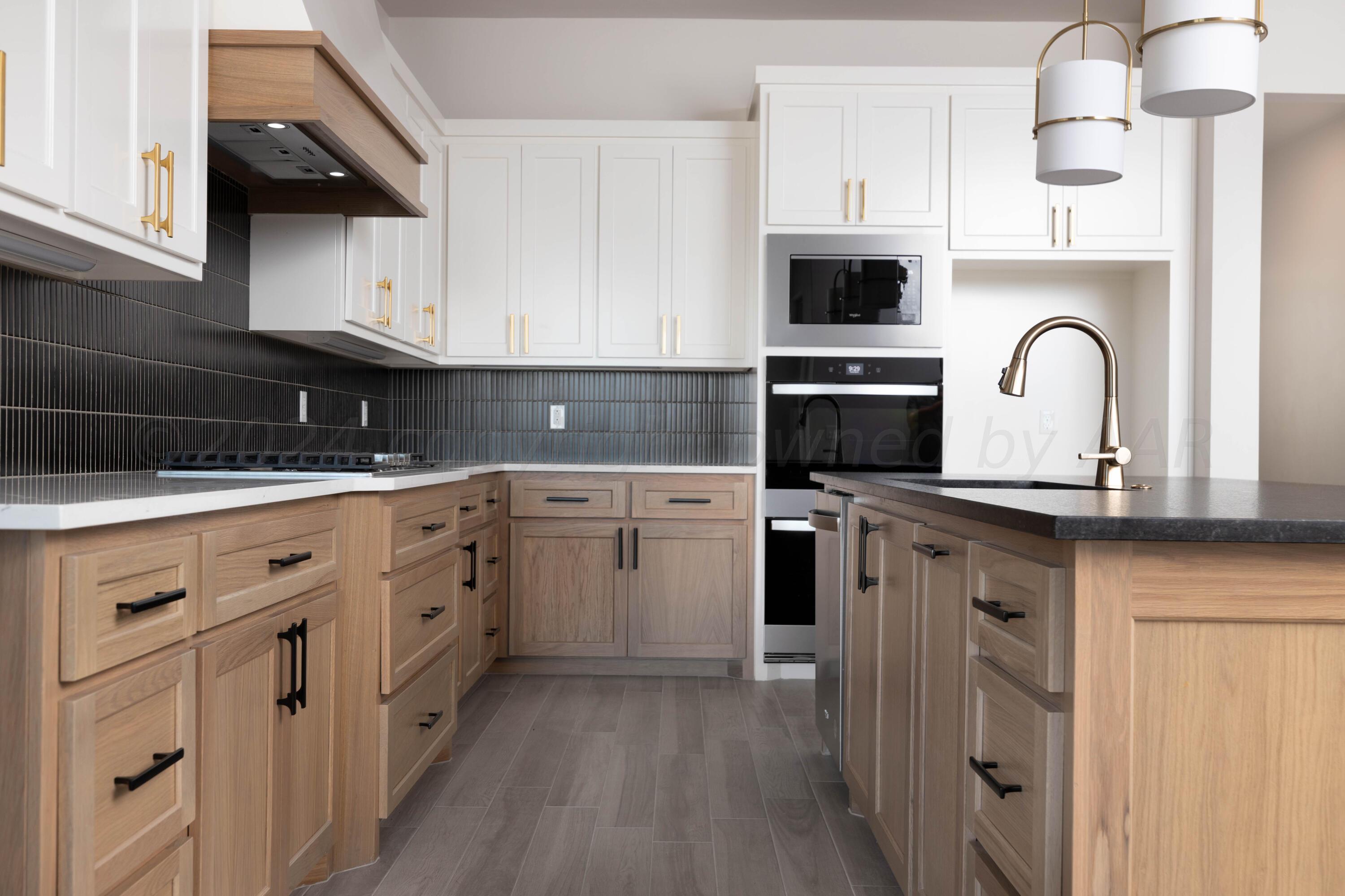 10201 Cactus Flower Road Amarillo, TX 79119 - Photo 8 of 48 a kitchen with white cabinets stainless steel appliances and sink