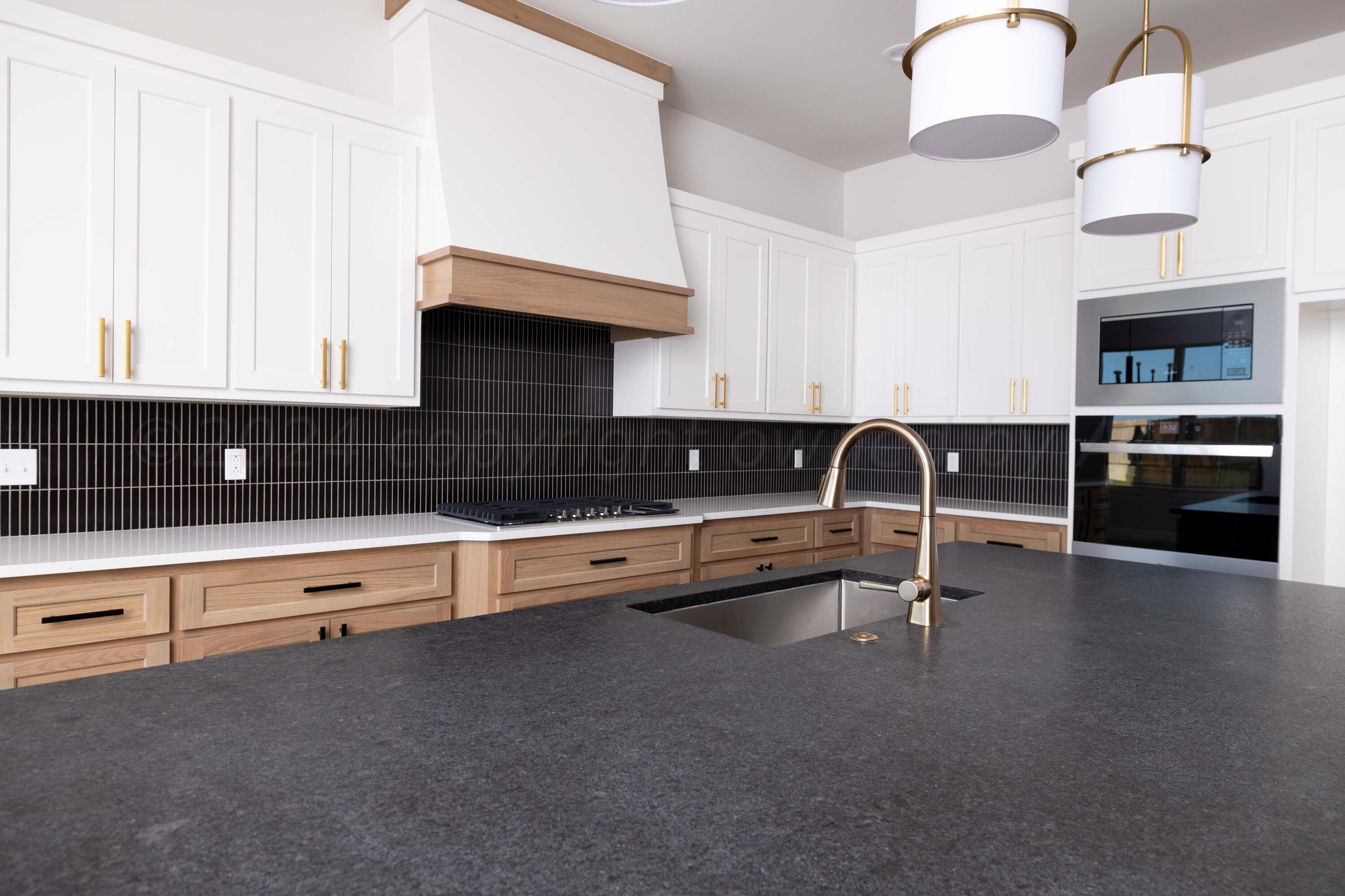 10201 Cactus Flower Road Amarillo, TX 79119 - Photo 10 of 48 a kitchen with granite countertop a stove and a sink