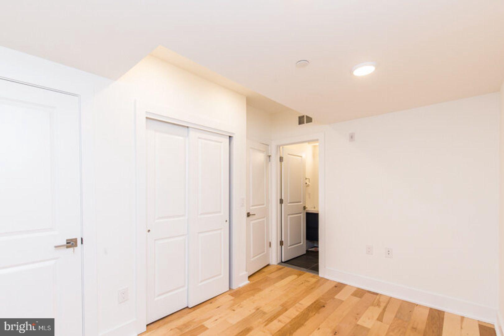 4100 Ludlow Street, Unit 1N Philadelphia, PA 19104 - Photo 5 of 16 a view of a big room with closet and wooden floor