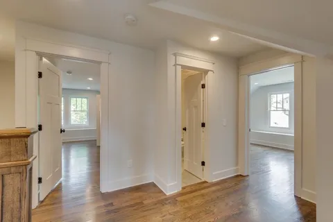 a view of a house with large windows and a small yard
