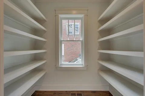 a view of walk in closet with empty racks
