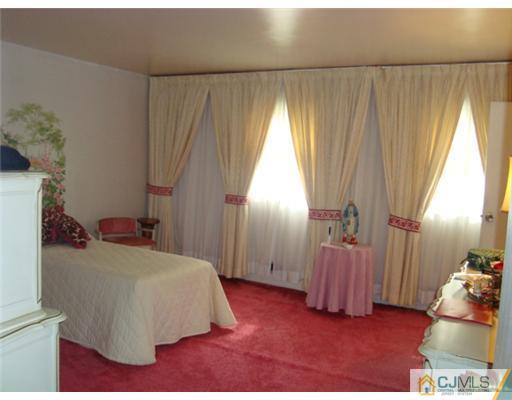 12 Hilltop Road Edison, NJ 08820 - Photo 12 of 23 a bedroom with a bed and a window