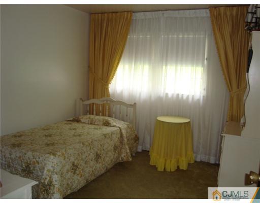 12 Hilltop Road Edison, NJ 08820 - Photo 14 of 23 a bedroom with a bed and a dresser