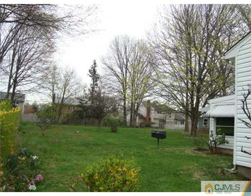12 Hilltop Road Edison, NJ 08820 - Photo 21 of 23 a front view of a house with a yard