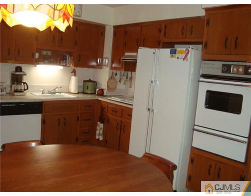 12 Hilltop Road Edison, NJ 08820 - Photo 8 of 23 a kitchen with a refrigerator and a stove