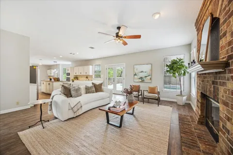 a living room with furniture a fireplace and a flat screen tv