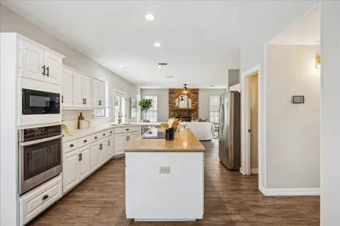 a kitchen with white cabinets sink and white appliances