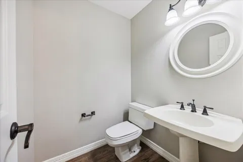 a white toilet sitting next to a bathroom sink
