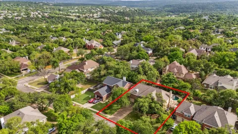 an aerial view of residential houses with outdoor space and street view