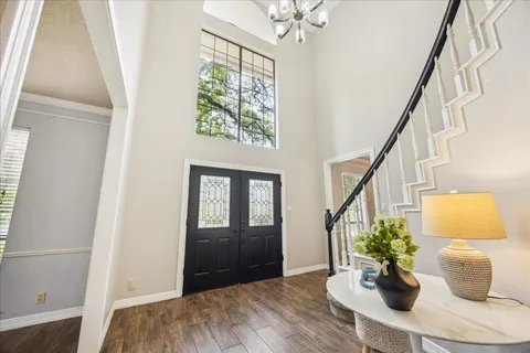 a dining room with furniture and a potted plant