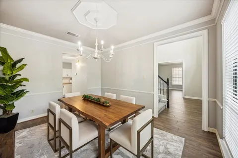 a view of a dining room with furniture and wooden floor