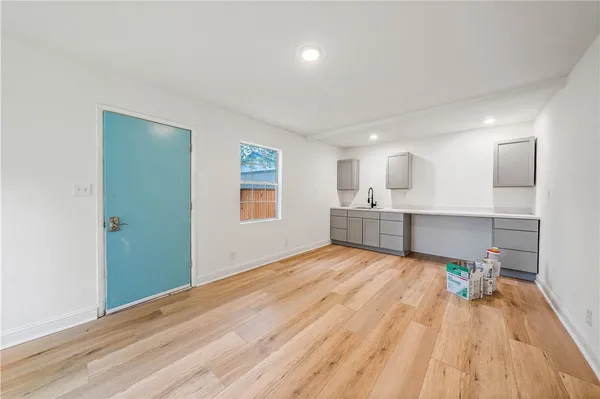 a view of a kitchen with wooden floor and a sink