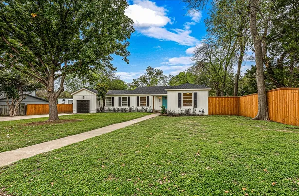 a front view of a house with yard