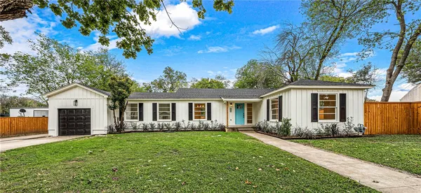 a front view of house with yard and green space