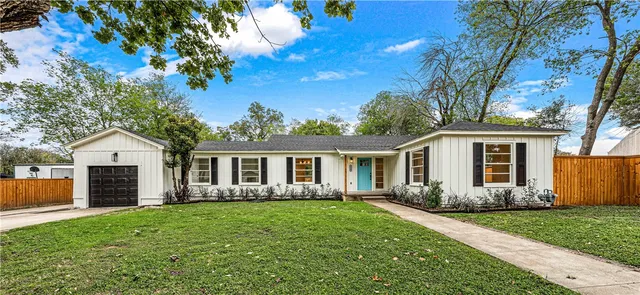 a front view of house with yard and green space