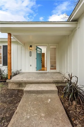 a view of a big room with wooden floor a ceiling fan and windows