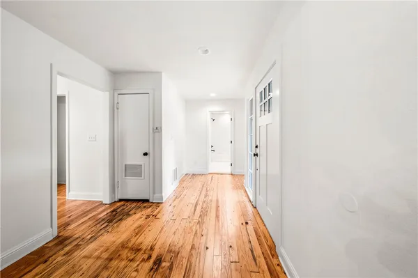 a kitchen with sink cabinets and wooden floor