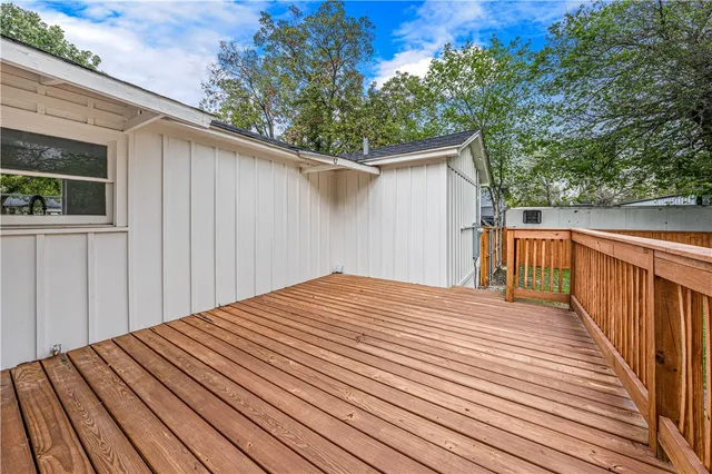 a view of a backyard with wooden fence