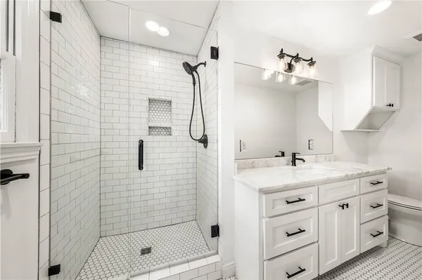a bathroom with a sink a toilet and shower