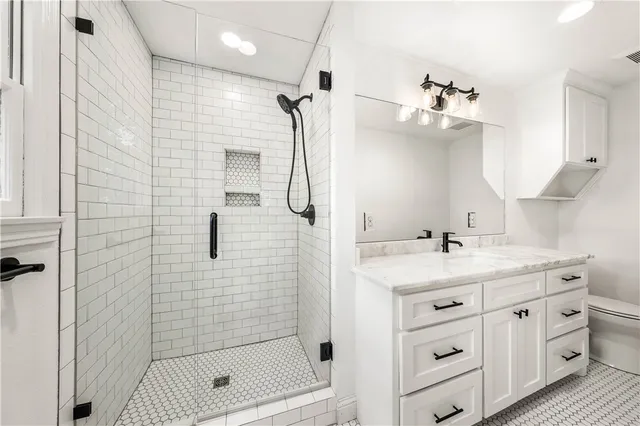 a bathroom with a sink a toilet and shower