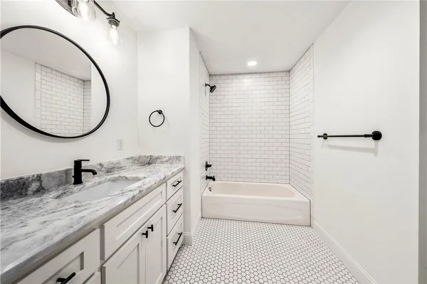 a bathroom with a granite countertop sink a toilet and a mirror
