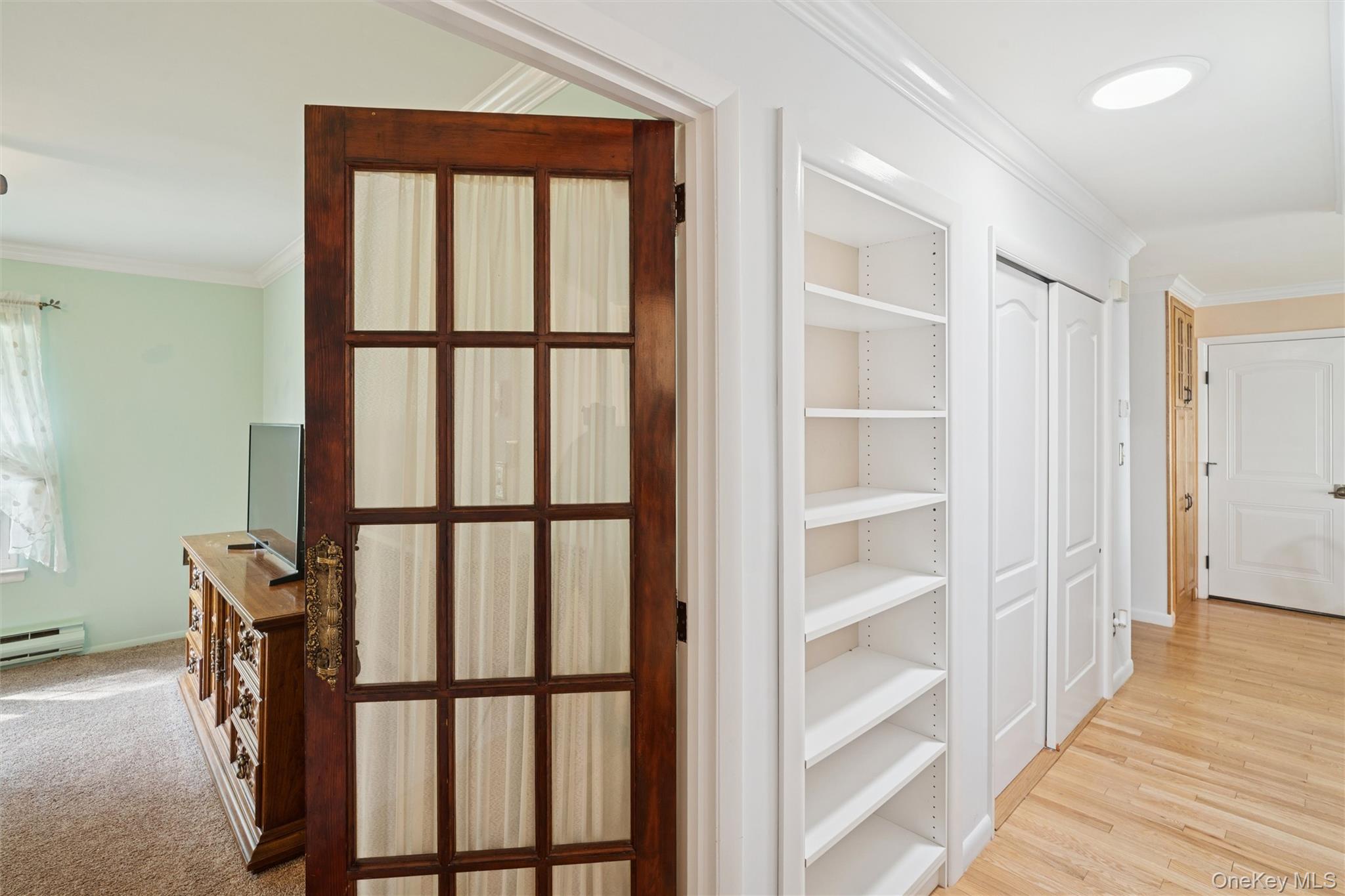 474 Darwen Drive, Unit B Ridge, NY 11961 - Photo 12 of 34 a view of a hallway with wooden floor and windows