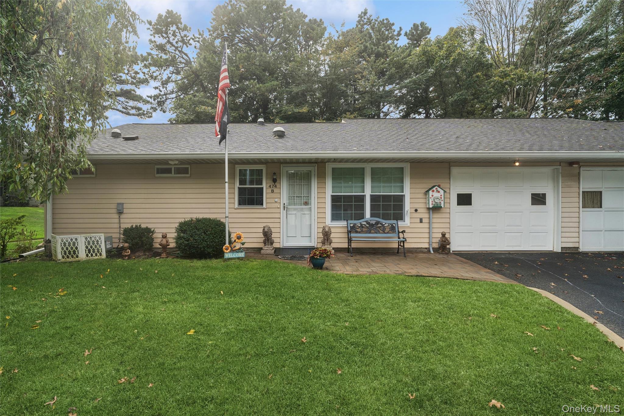 474 Darwen Drive, Unit B Ridge, NY 11961 - Photo 2 of 34 a backyard of a house with table and chairs