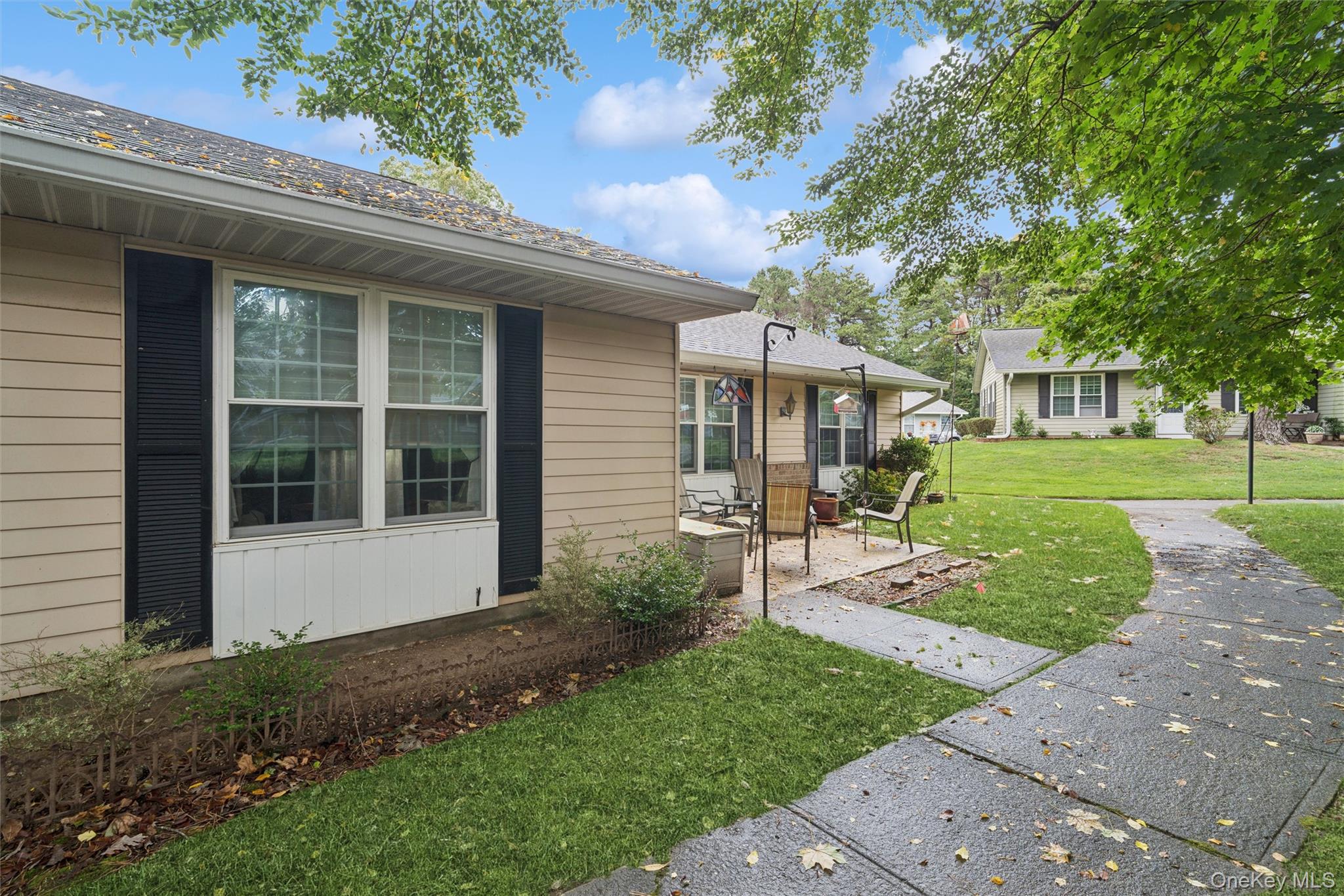 474 Darwen Drive, Unit B Ridge, NY 11961 - Photo 23 of 34 a front view of a house with a yard