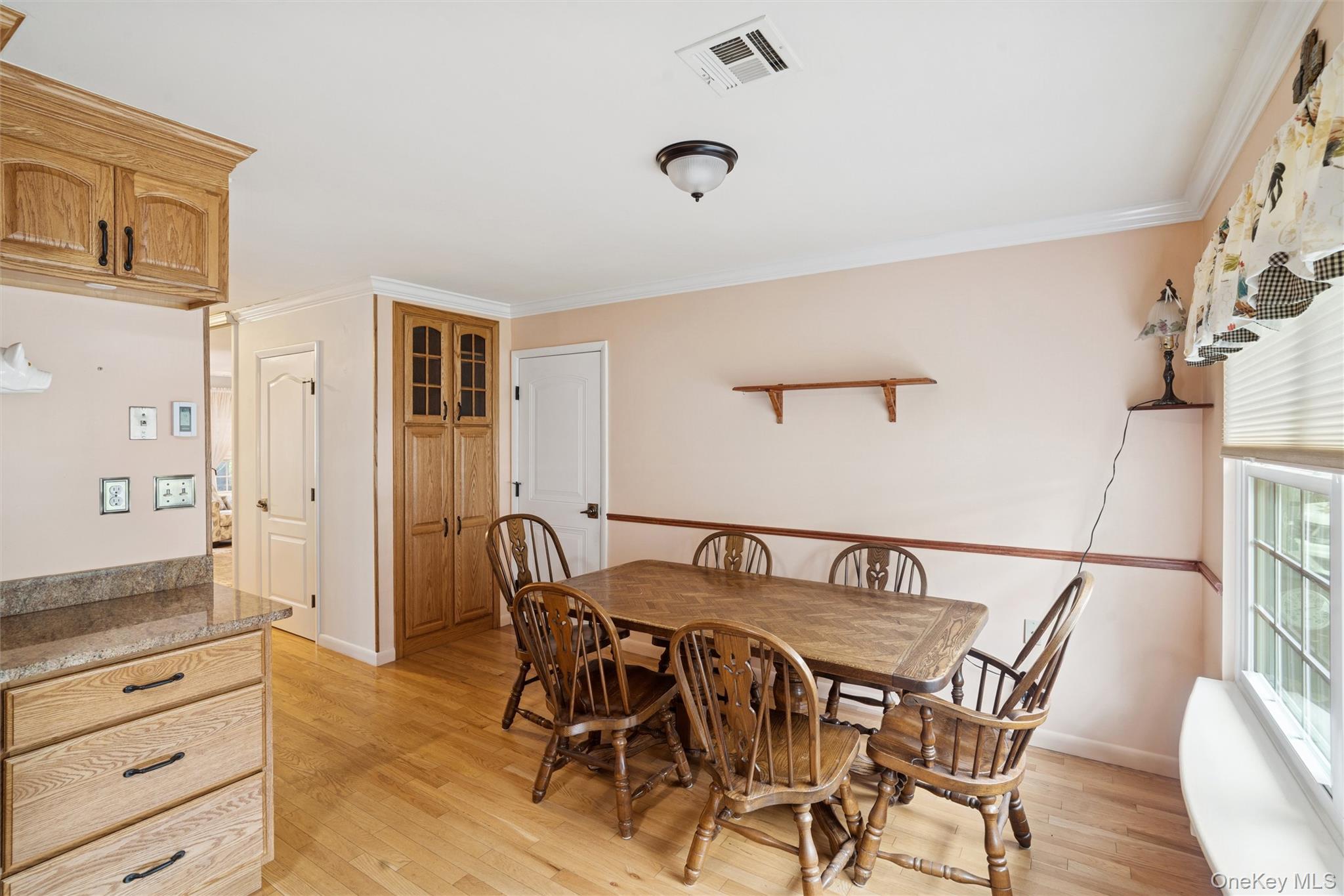 474 Darwen Drive, Unit B Ridge, NY 11961 - Photo 5 of 34 a view of a dining room with furniture and wooden floor
