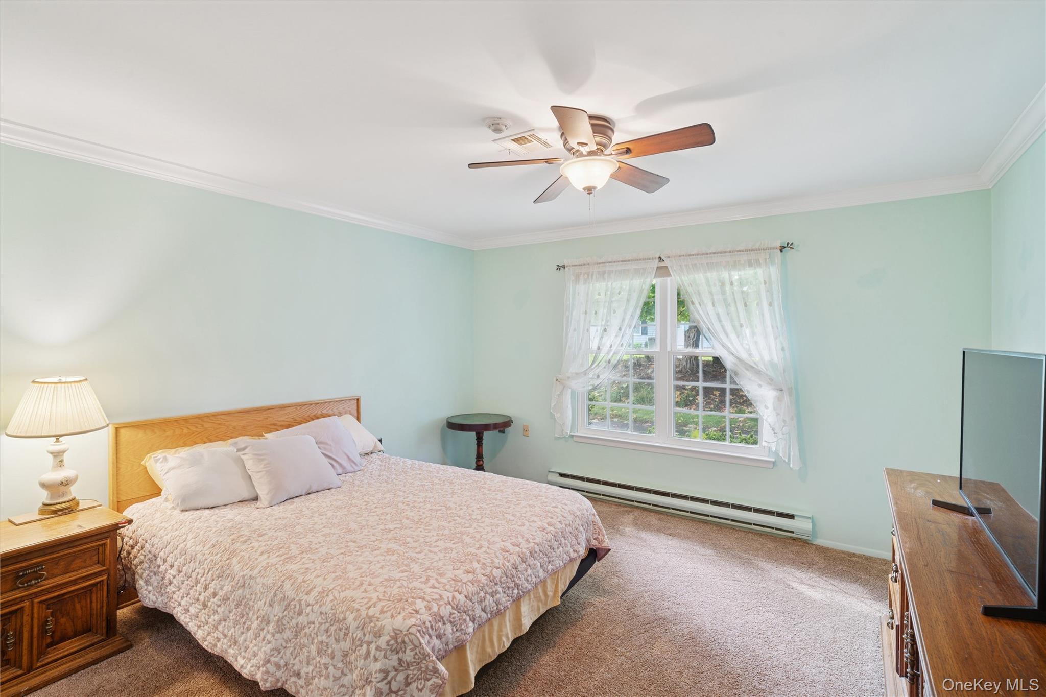 474 Darwen Drive, Unit B Ridge, NY 11961 - Photo 8 of 34 a bedroom with a large bed and a window