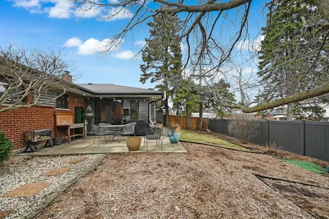 a view of a house with backyard porch and sitting area