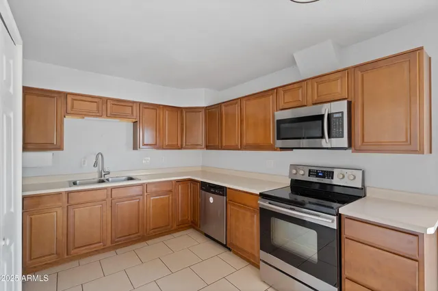 a kitchen with a sink stove and microwave