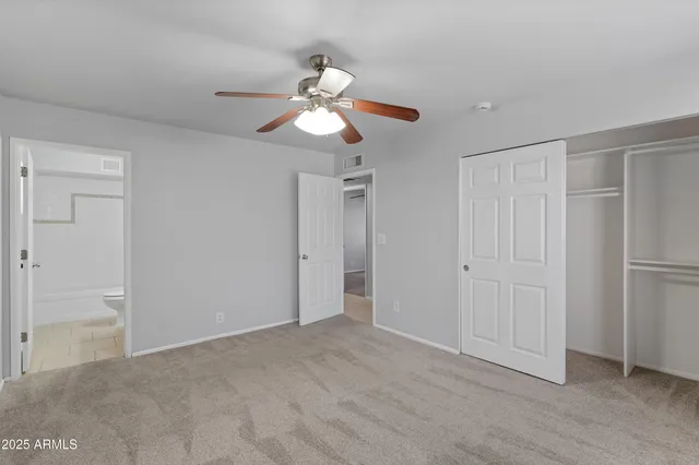 a view of an empty room and closet area