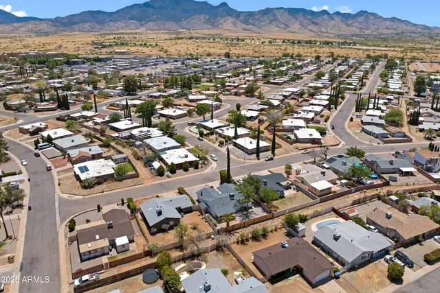an aerial view of residential houses with outdoor space