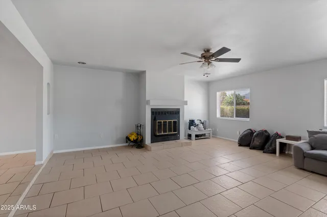 a view of a livingroom with furniture and a ceiling fan