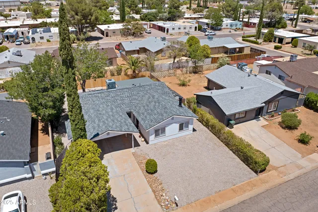 an aerial view of a houses with yard