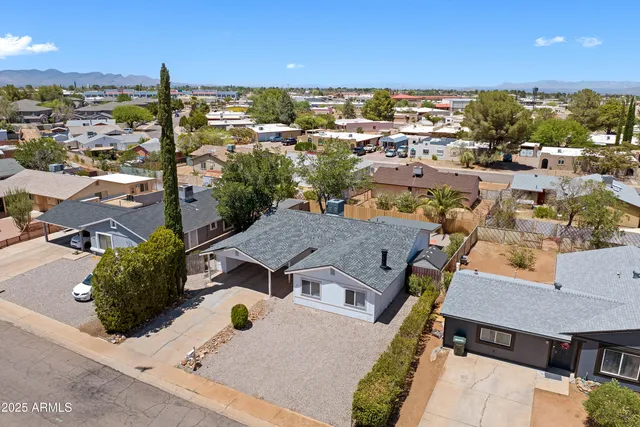 an aerial view of residential houses with city view