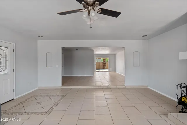 a view of a livingroom with a ceiling fan and window