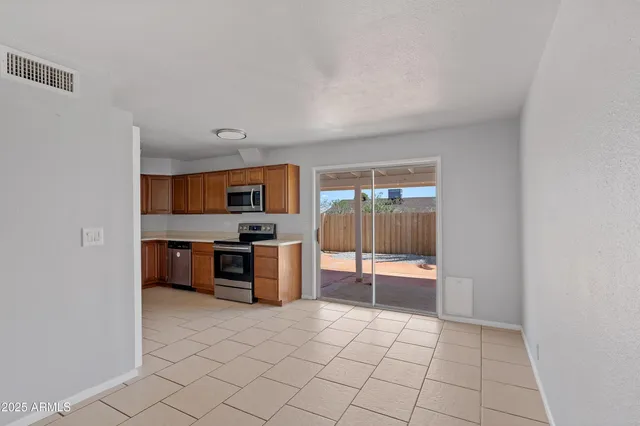 a large white kitchen with a sink and cabinets