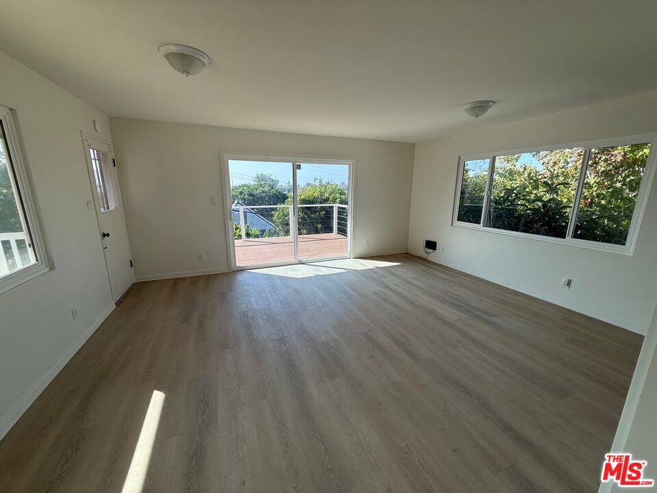 3237 Midvale Avenue Los Angeles, CA 90034 - Photo 12 of 24 a view of an empty room with wooden floor and a window