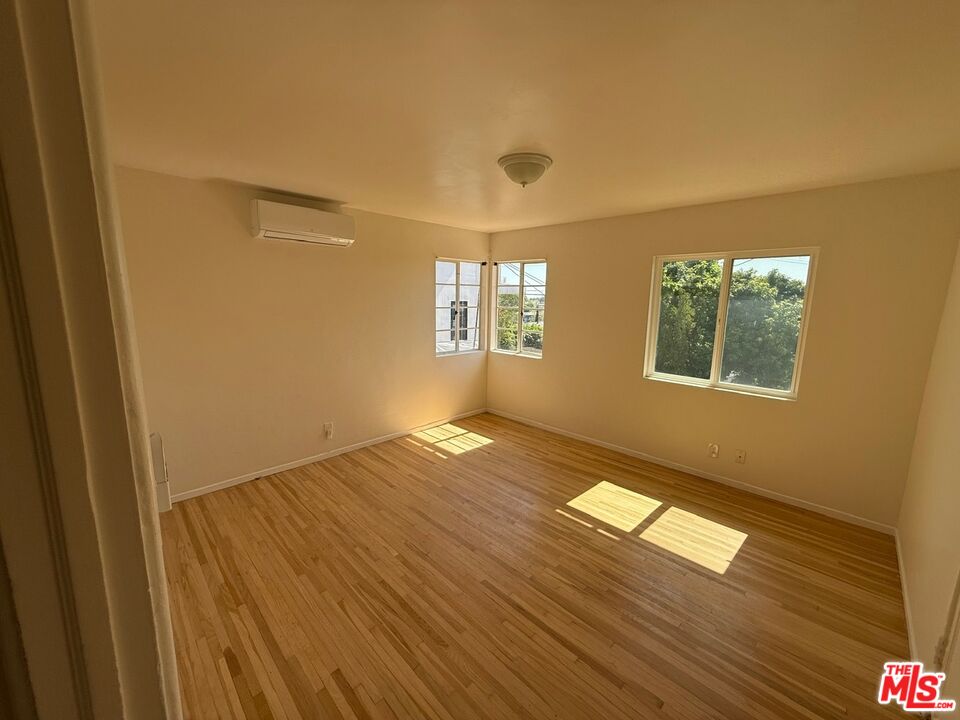 3237 Midvale Avenue Los Angeles, CA 90034 - Photo 17 of 24 a view of empty room with wooden floor and fan